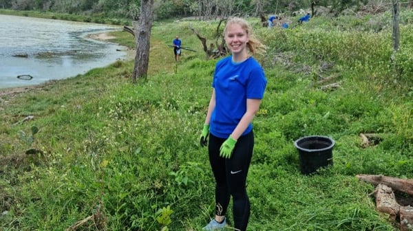 Young woman clearing vegetation